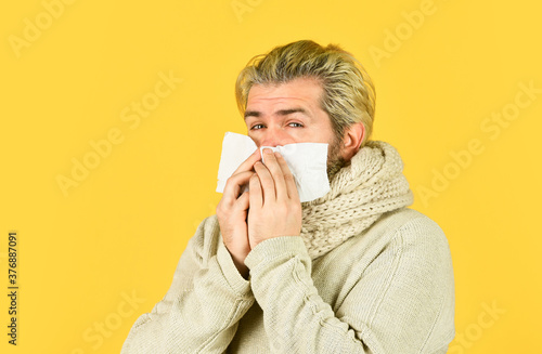 on a sick leave. immunity against epidemic. hipster sneezing and blow out nose. Allergy reaction. inflammatory process. sick man has runny nose. flu virus infection symptoms. coronavirus from china