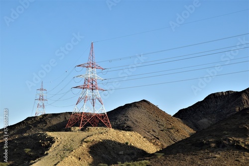 Electrical tower in the mountain under blue sky. Muscat, Oman