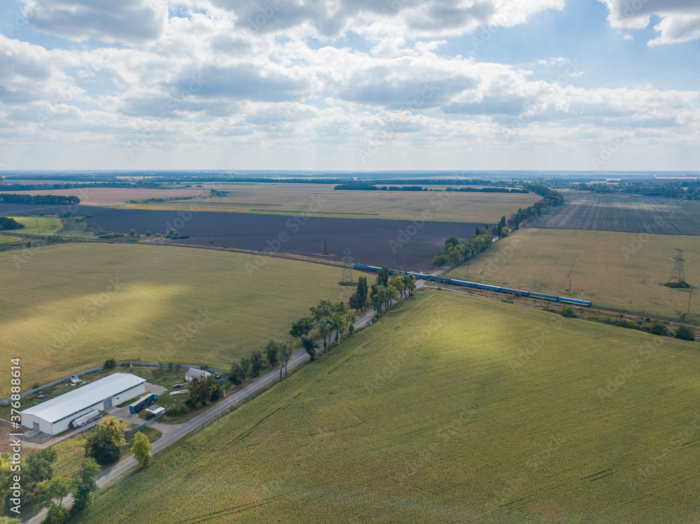 Aerial drone view. Railroad through agricultural fields.