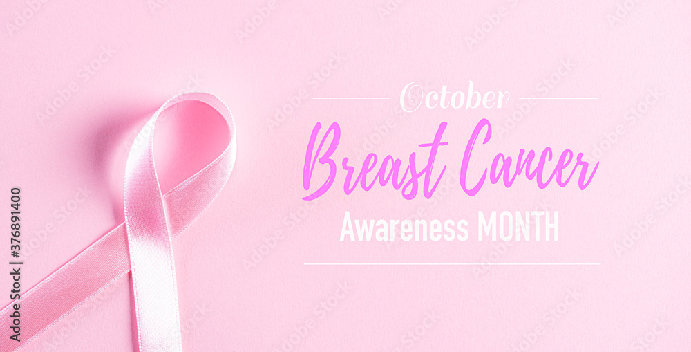 Fototapeta premium Pink ribbon on pink pastel paper background for supporting breast cancer awareness month campaign.