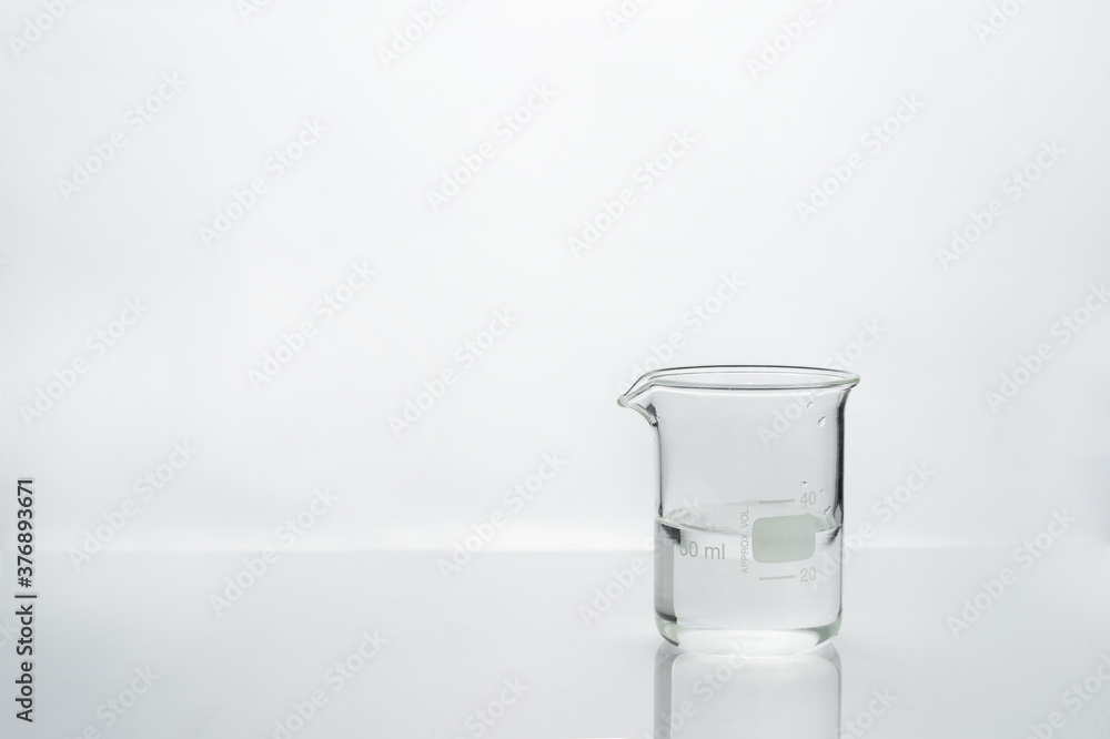 water in glass beaker with white medical health laboratory background water in glass beaker with white medical health laboratory background