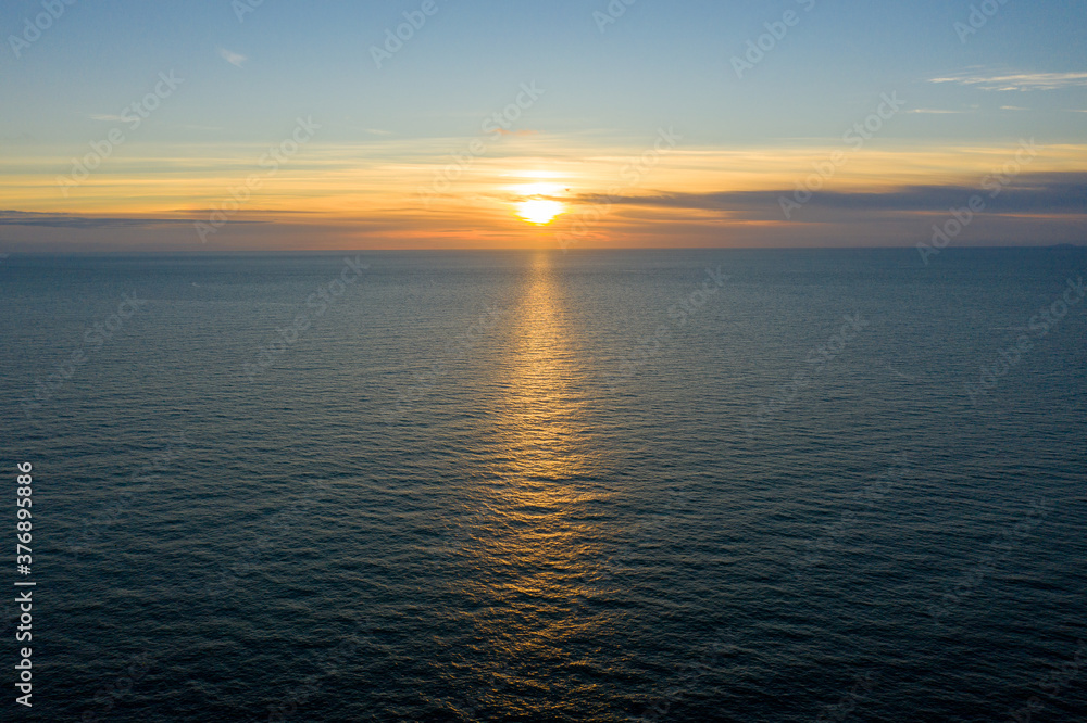 Clean simple aerial view of a sunset / sunrise over the ocean