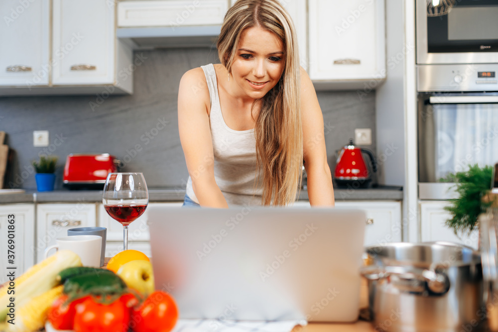 Young pretty woman cooking something in her kitchen Young pretty woman cooking something in her kitchen