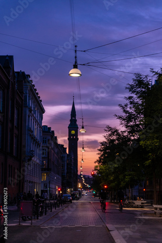 Street with people on bicycle at sunset in Copenhagen, Denmark