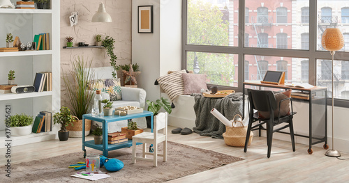 Modern decorative living room corner and city view, child object interior style. Work table and laptop. © UnitedPhotoStudio