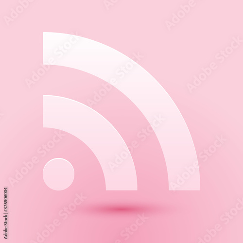 Paper cut RSS icon isolated on pink background. Radio signal. RSS feed symbol. Paper art style. Vector.
