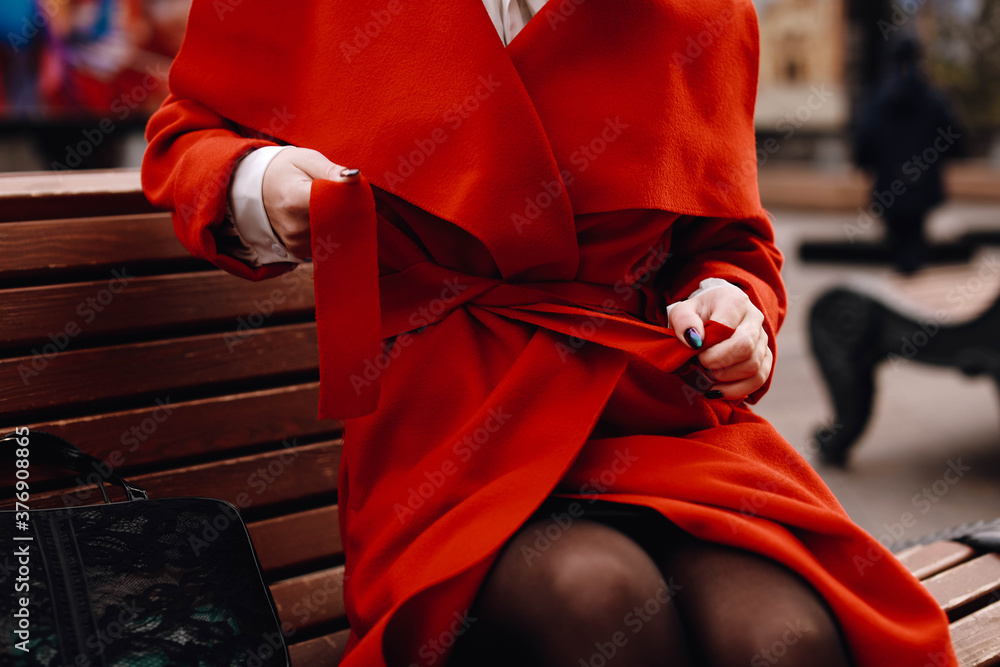 Female hands on a red classic jacket. Fashion stylish shot. .