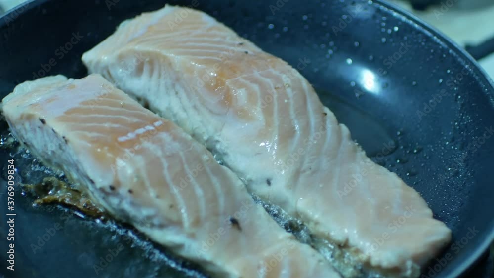 POV to the fresh salmon while being grilled in pan-slamon steak POV to the fresh salmon while being grilled in pan-slamon steak