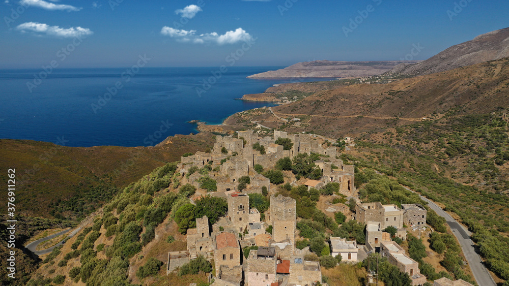 Obraz premium Aerial drone photo of picturesque abandoned old stone tower village of Vatheia overlooking deep blue sea in Mani Peninsula, Peloponnese, Greece