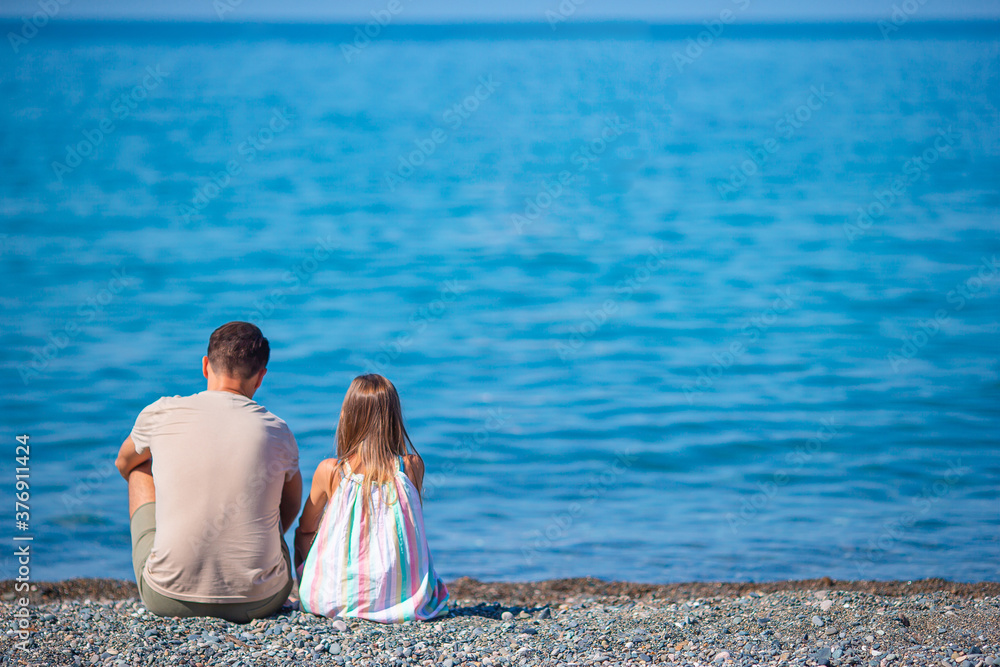 Little girl and happy dad having fun during beach vacation Little girl and happy dad having fun during beach vacation