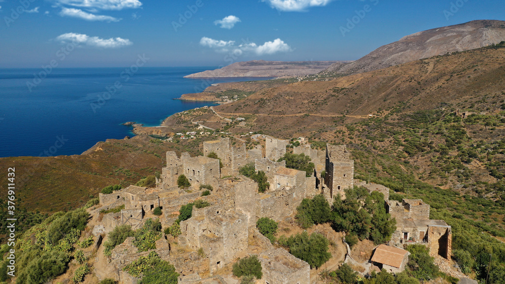 Aerial drone photo of picturesque abandoned old stone tower village of Vatheia overlooking deep blue sea in Mani Peninsula, Peloponnese, Greece