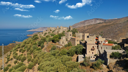 Aerial drone photo of picturesque abandoned old stone tower village of Vatheia overlooking deep blue sea in Mani Peninsula, Peloponnese, Greece