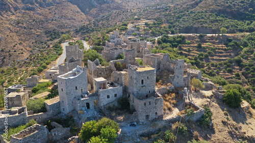 Aerial drone photo of picturesque abandoned old stone tower village of Vatheia overlooking deep blue sea in Mani Peninsula, Peloponnese, Greece © aerial-drone