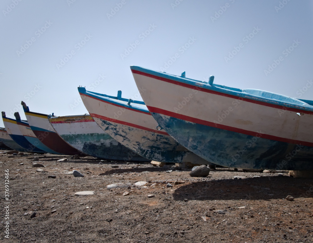 Fishing boats of different colors out of the water Fishing boats of different colors out of the water