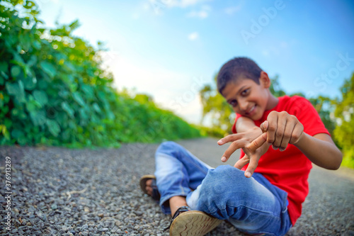 indian child playing with stone photo