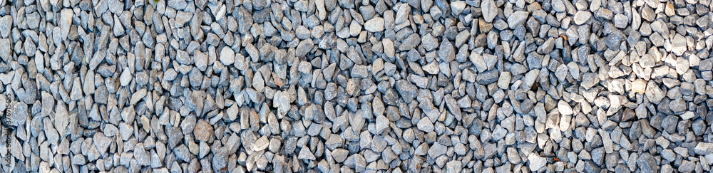 small road stone panorama background. dark gravel pebbles stone texture small road stone panorama background. dark gravel pebbles stone texture
