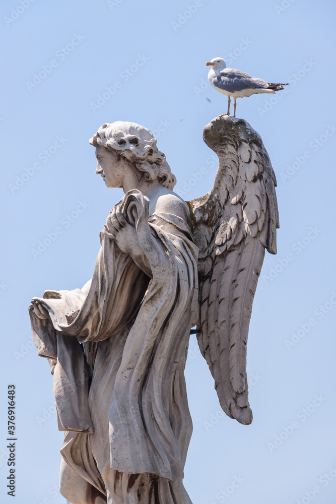 One of the famous statues of angels, the one with the dices, on the Sant'Angelo bridge near the Castle of the same name.
