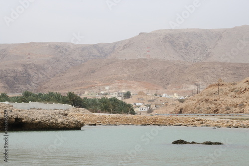 Qalhat, Beach in Oman and Mountains of Hajar  photo