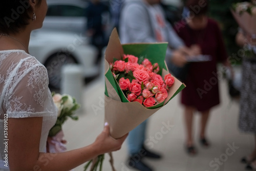 A bouquet of flowers in the girl's hand. photo