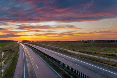 beautiful, fiery sunset over the highway © Mike Mareen
