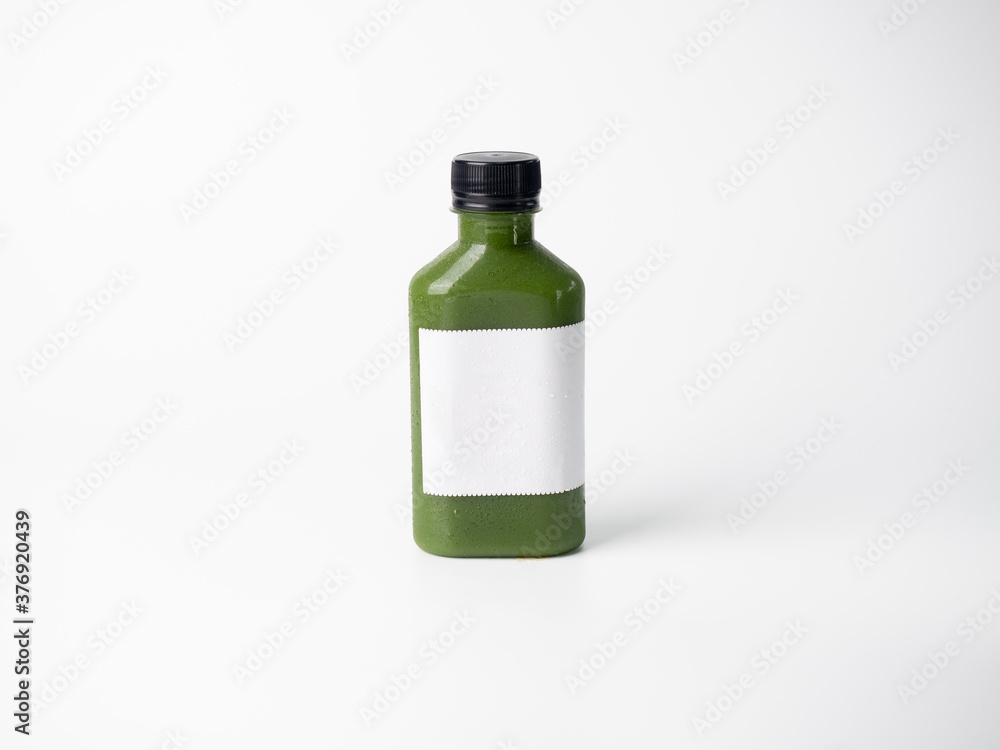 green pastel color drink in plastic bottle container with empty logo label. mixed many vegetables and fruits smoothie juice on studio background. green pastel color drink in plastic bottle container with empty logo label. mixed many vegetables and fruits smoothie juice on studio background.