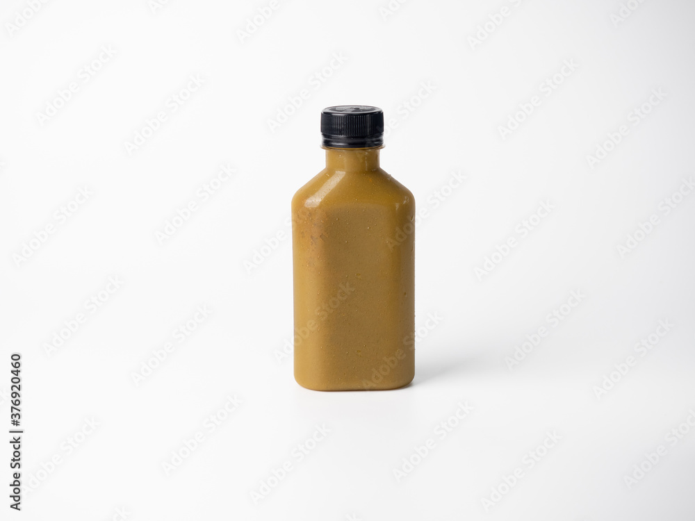 brown pastel color drink in plastic bottle container with empty logo label. mixed many vegetables and fruits smoothie juice on studio background. brown pastel color drink in plastic bottle container with empty logo label. mixed many vegetables and fruits smoothie juice on studio background.