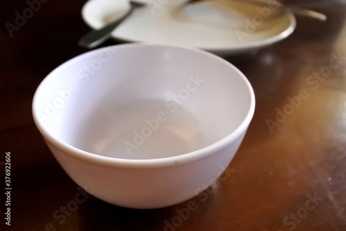Small empty bowl on wooden table background