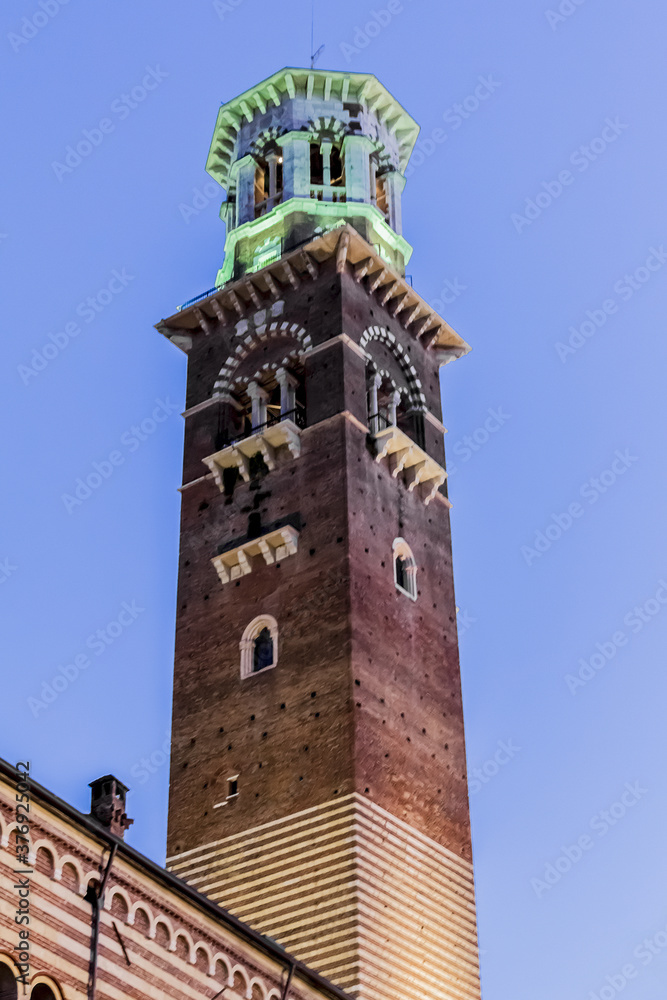 Medieval tower of Lamberti (Torre dei Lamberti, XI century) at evening. 84 m Lamberti Tower in Verona is UNESCO world heritage site. Italy, Europe.