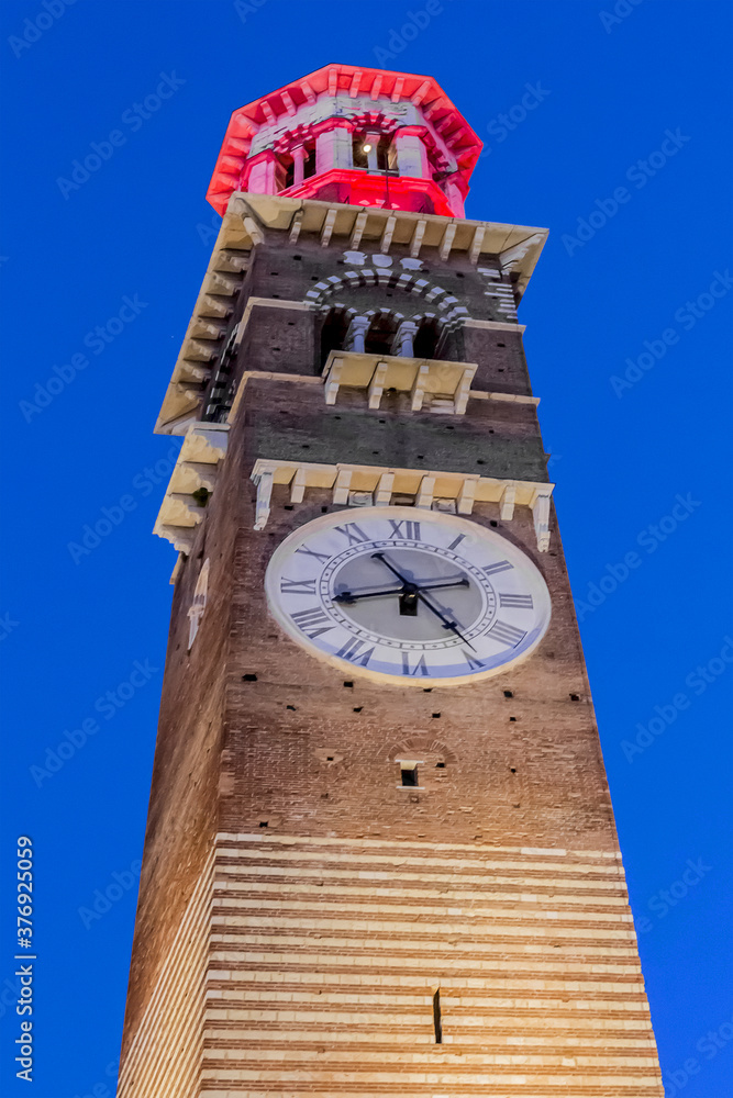 Medieval tower of Lamberti (Torre dei Lamberti, XI century) at evening. 84 m Lamberti Tower in Verona is UNESCO world heritage site. Italy, Europe.