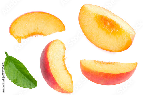 peach fruit with green leaf and slices isolated on white background. top view