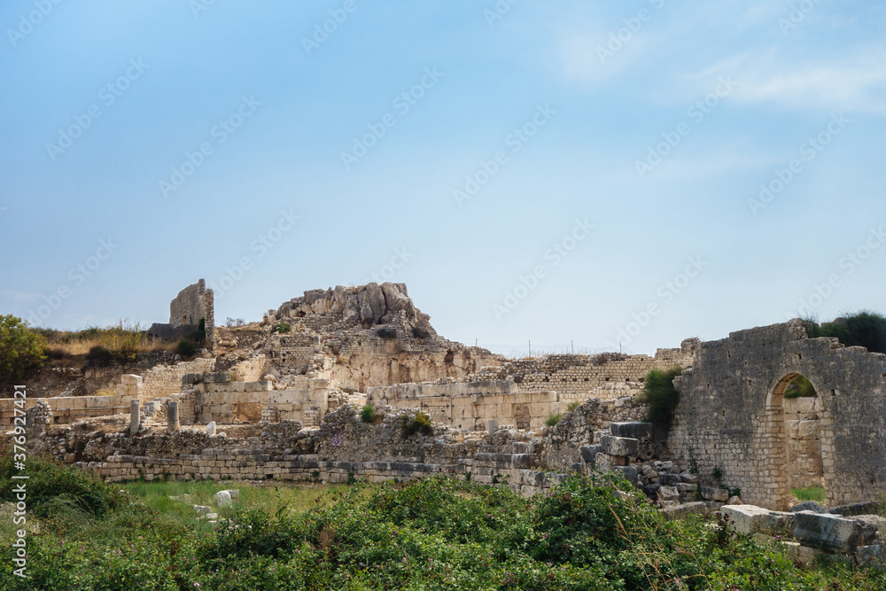 Panoramic view onto ruined Byzantine palace in ancient city Elaiussa Sebaste, near Kızkalesi, Turkey. There are remains of walls, columns & archs. City was abandoned in medieval times