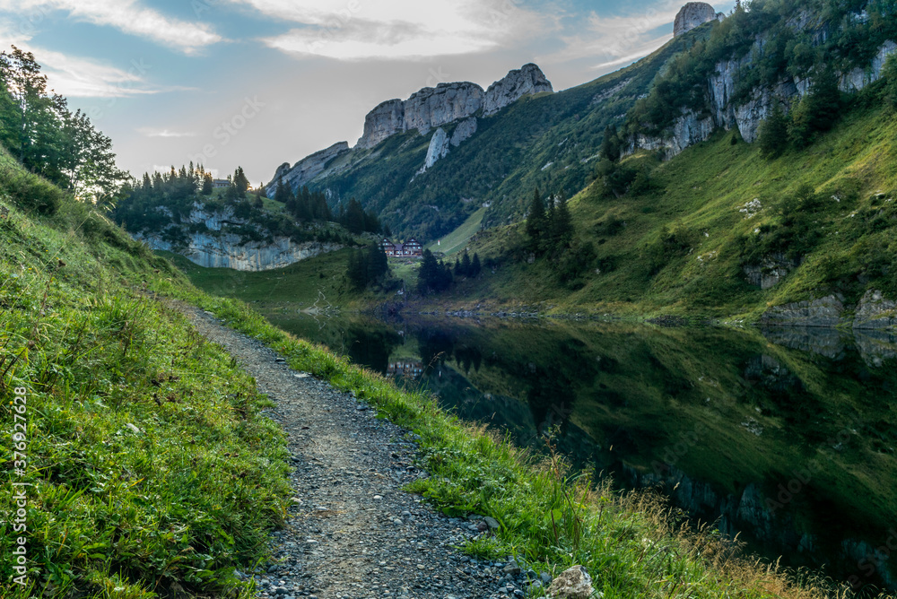 The mountain hut and the Alpstein mountain range reflecting on the Faelensee lake in the Swiss canton of Appenzell at sunrise The mountain hut and the Alpstein mountain range reflecting on the Faelensee lake in the Swiss canton of Appenzell at sunrise