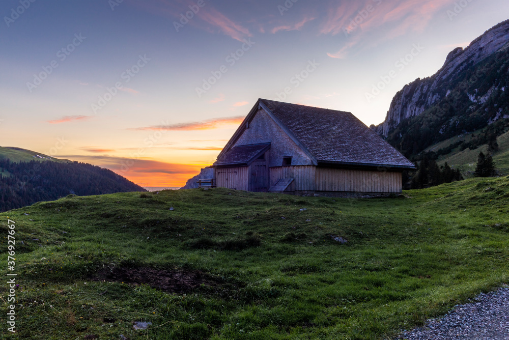 A typical Appenzeller hut on the Alpstein mountain range at sunrise