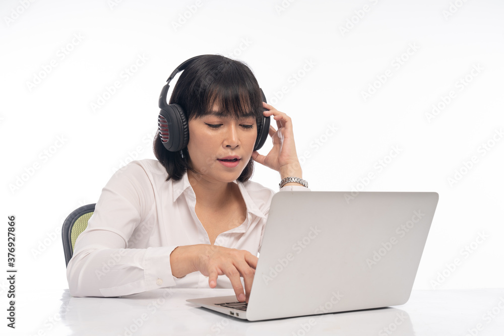 Office woman wearing headphones for online meeting on laptop Office woman wearing headphones for online meeting on laptop