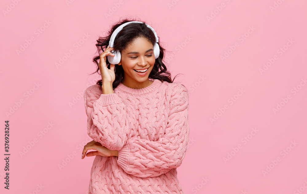 Delighted ethnic woman enjoying music. Delighted ethnic woman enjoying music.