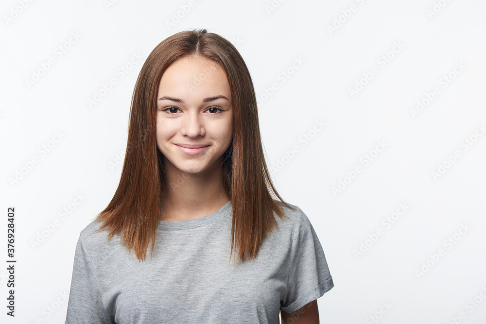 Smiling relaxed teen girl looking at camera Smiling relaxed teen girl looking at camera