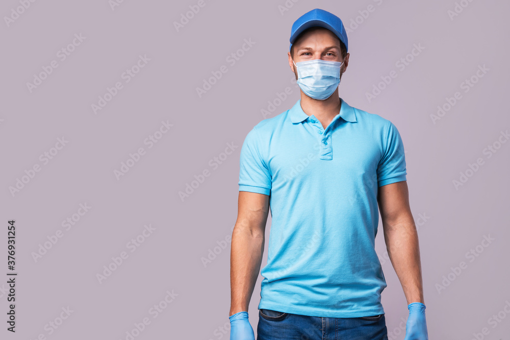 Young man wearing blue uniform with a prevention mask and gloves Young man wearing blue uniform with a prevention mask and gloves