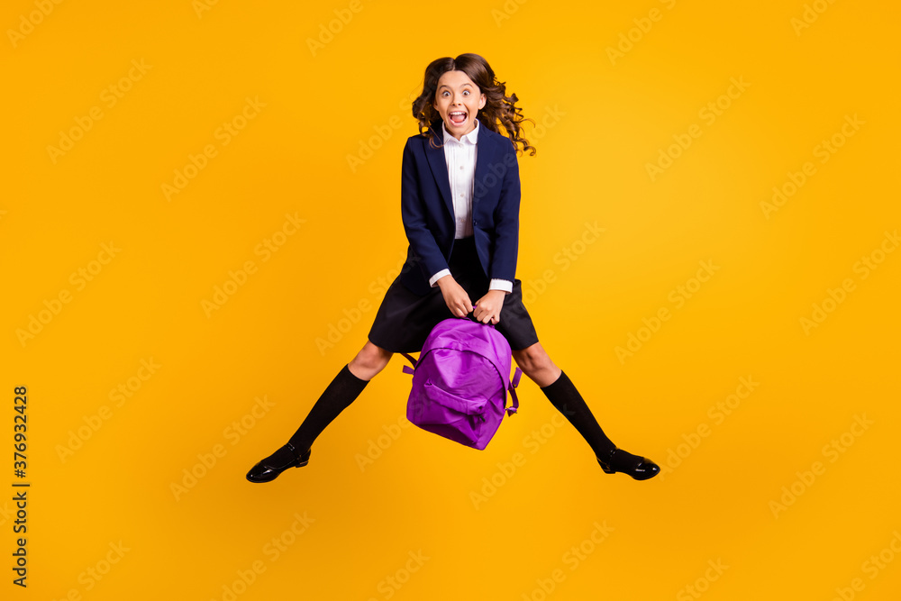 Full length body size view of her she attractive small little overjoyed cheerful ecstatic girl jumping having fun back to school college isolated bright vivid shine vibrant yellow color background