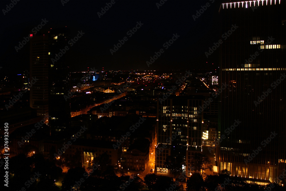 beautiful view from a height, from the window to the night modern European city of Frankfurt am Main with lights, tall skyscrapers, the concept of global business, traffic
