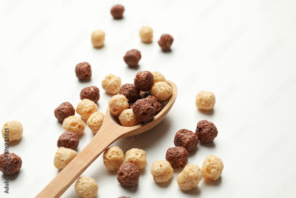 Obraz premium Spoon with corn balls on white background