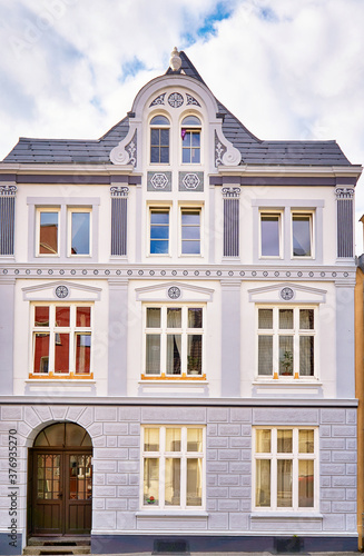 Gray old gabled house facade with white wooden windows in the old town of Wismar.