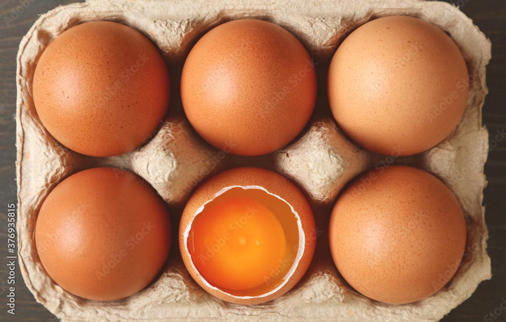 Pack of fresh organic eggs with an opened shell one in the carton box Pack of fresh organic eggs with an opened shell one in the carton box