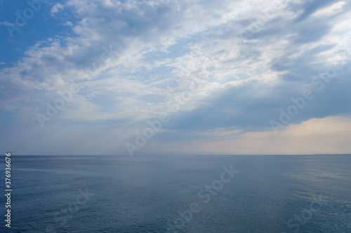 View onto Mediterranean sea from top of Kizkalesi fortress, Turkey. There are empty horizon, clouds, small rain in central part © Poliorketes
