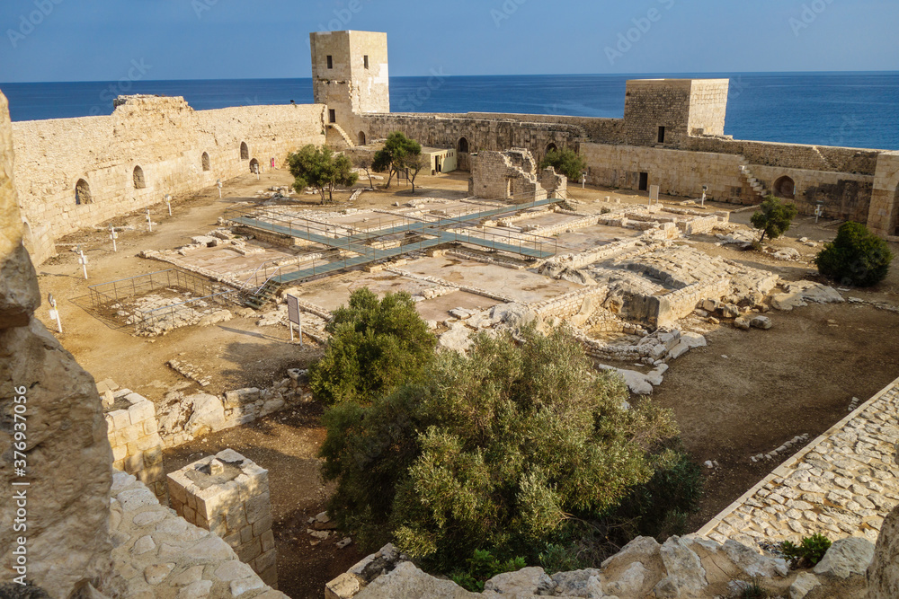 Panoramic view onto medieval fortress Kizkalesi from tower. There are ruins of military barracks & chapel. All buildings have floor mosaics. Mediterranean sea on background. Shot in Kizkalesi, Turkey
