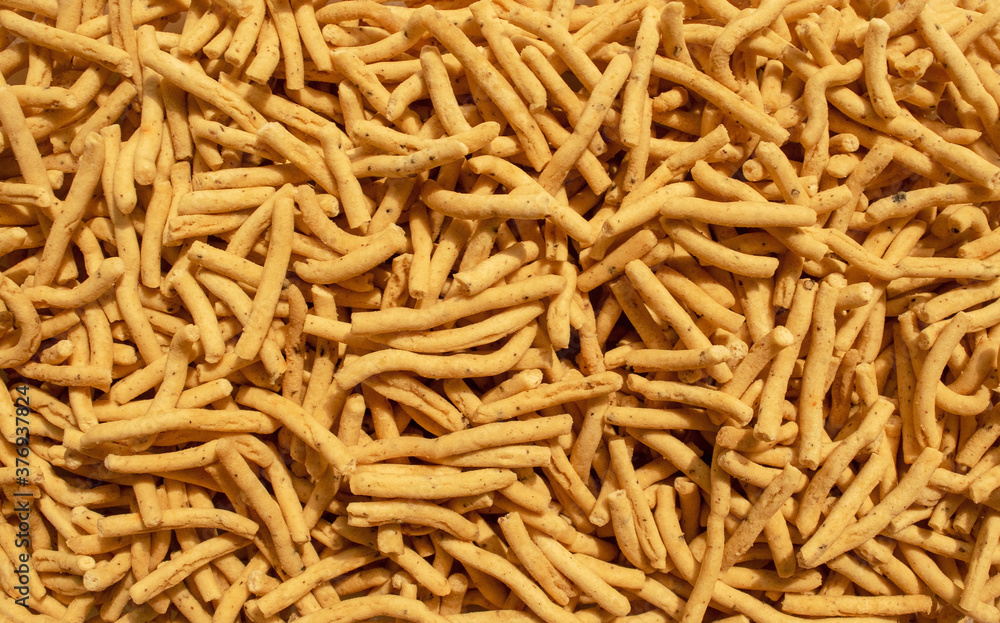 Ratlami Sev background. Popular Gujarati snack. Ratlami Masala Sev. Top view. Indian street snack.