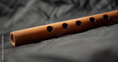 Fotografija Bamboo flute on black background