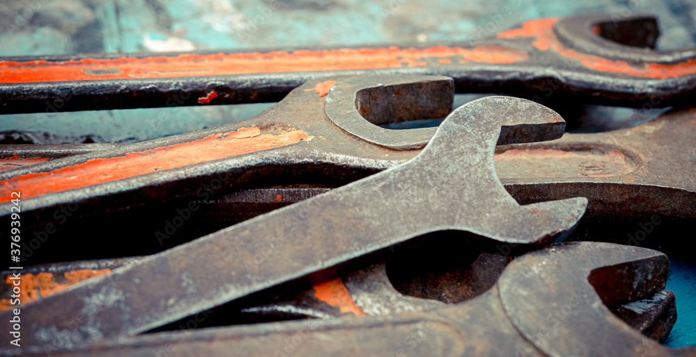 Old spanners. Grunge background of instruments. Keys close-up. Vintage turquoise and red Old spanners. Grunge background of instruments. Keys close-up. Vintage turquoise and red