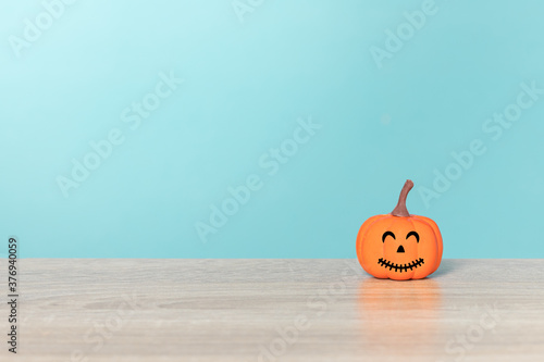 Halloween holiday concept with jack o lantern smiling face and blue background