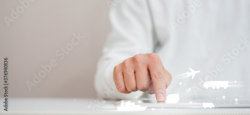 close up on man hand touching on digital tablet screen to shopping online on e-commerce website and select transportation delivery function concept