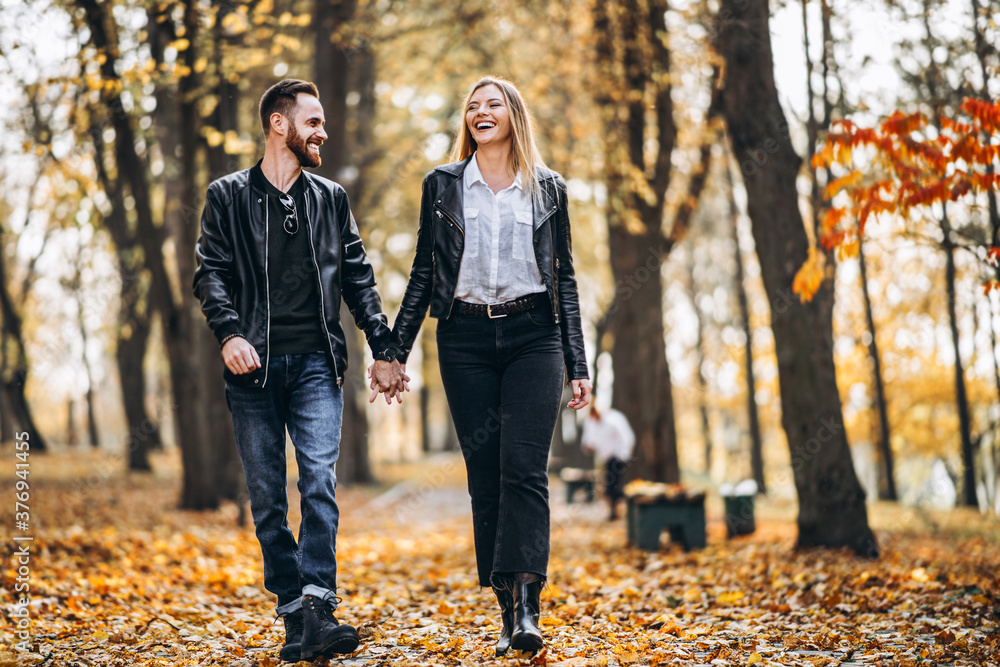 Portrait of a happy loving couple walking outdoor in the autumn park Portrait of a happy loving couple walking outdoor in the autumn park